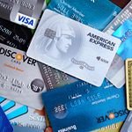 Close-up image of various credit cards including Visa, Mastercard, and American Express.