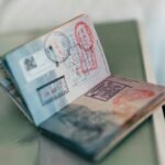 An open passport with multiple colorful ink stamps on the pages